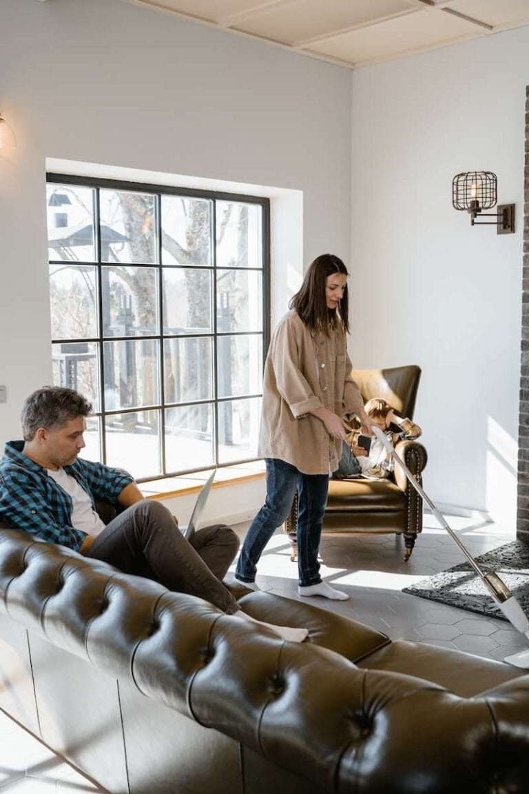 Freshen Up Fast: How To Dry A Mattress After Bedwetting 4 A Man Sitting on the Couch while Looking at the Woman Cleaning the Floor
