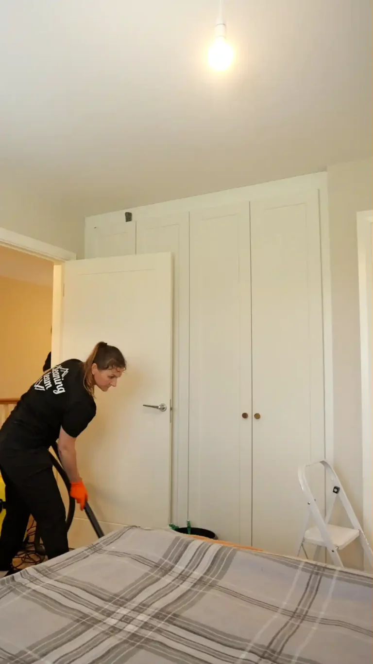 cleaning team member cleaning the bedroom