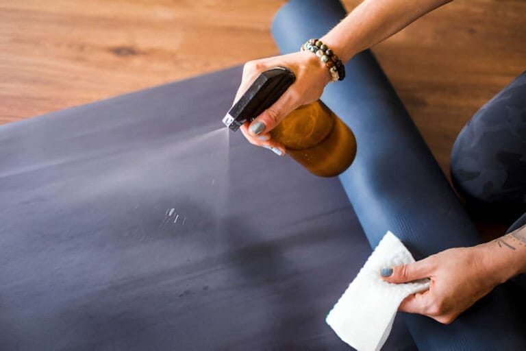 Yoga Mat Cleaning 101: Tips for Better Hygiene & Practice 4 cleaning yoga mat with cloth and cleaning solution